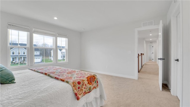 bedroom with light colored carpet, baseboards, visible vents, and recessed lighting