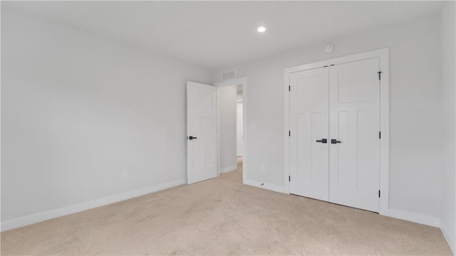 unfurnished bedroom with baseboards, recessed lighting, and carpet