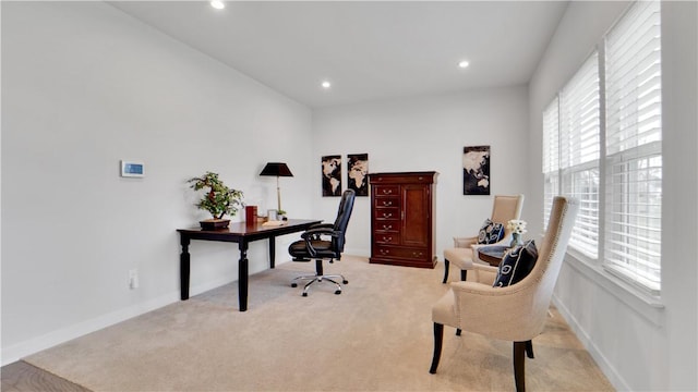 office area with light colored carpet, a wealth of natural light, and baseboards