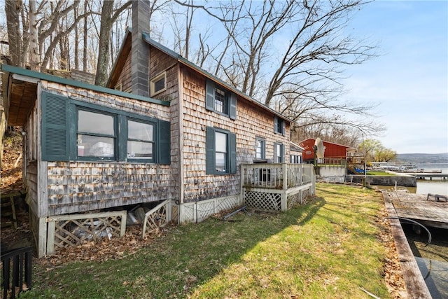 11519 E Lake Rd, Wayne, NY 14840 - view of property exterior featuring a yard, a chimney, and a deck