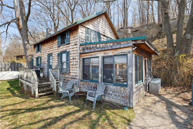 11519 E Lake Rd, Wayne, NY 14840 - back of house featuring a chimney, a sunroom, and a lawn