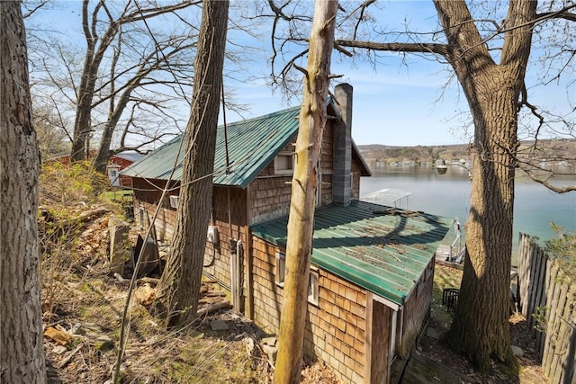 11519 E Lake Rd, Wayne, NY 14840 - view of property exterior featuring a water view, a chimney, metal roof, and a boat dock