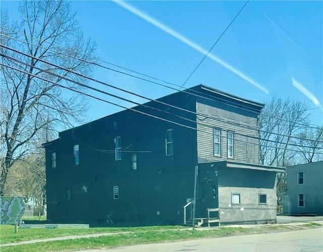 view of side of home with a yard