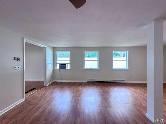 unfurnished room with a ceiling fan, cooling unit, dark wood-type flooring, baseboards, and a baseboard radiator