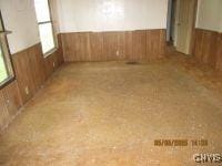 111 Maple Ave, Augusta, NY 13425 - unfurnished room featuring wood walls and a wainscoted wall