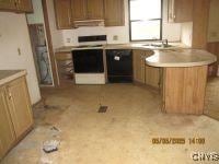 111 Maple Ave, Augusta, NY 13425 - kitchen with range, brown cabinetry, stainless steel oven, a peninsula, and light countertops