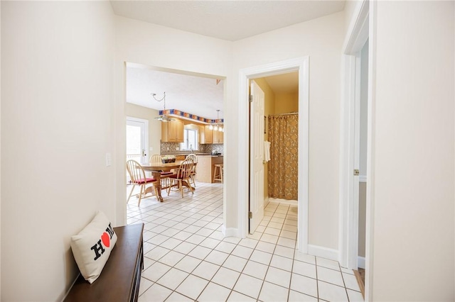 hallway featuring light tile patterned floors