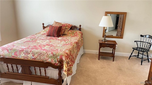 bedroom featuring baseboards and carpet