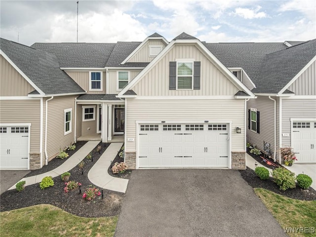 177 Sandstone Cir, Grand Island, NY 14072 - craftsman inspired home featuring stone siding, driveway, a garage, board and batten siding, and a shingled roof