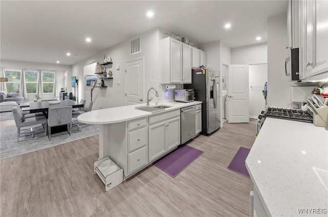 177 Sandstone Cir, Grand Island, NY 14072 - kitchen with light wood finished floors, visible vents, a sink, light countertops, and appliances with stainless steel finishes