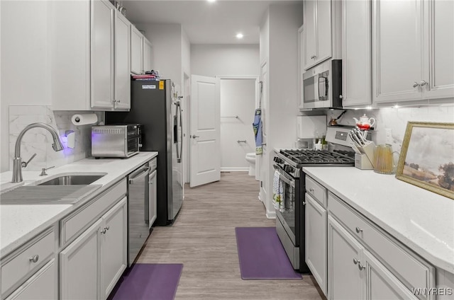 177 Sandstone Cir, Grand Island, NY 14072 - kitchen with a sink, stainless steel appliances, tasteful backsplash, light wood-type flooring, and recessed lighting