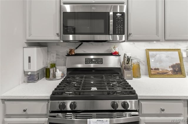 177 Sandstone Cir, Grand Island, NY 14072 - kitchen featuring light stone countertops, tasteful backsplash, and appliances with stainless steel finishes