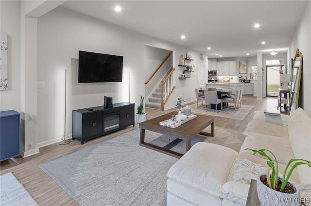 177 Sandstone Cir, Grand Island, NY 14072 - living room featuring baseboards, stairs, light wood-style flooring, and recessed lighting