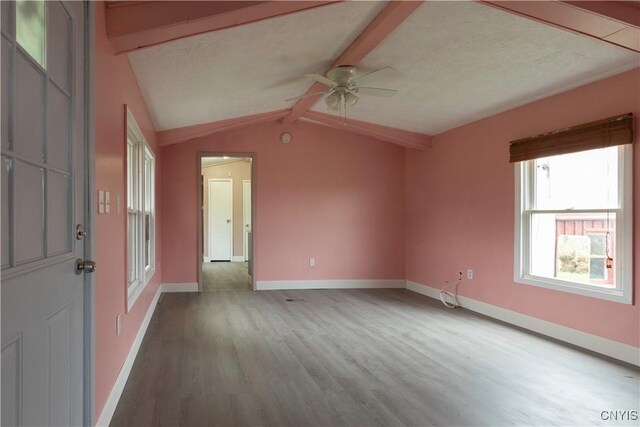 87 Kings Rd, Volney, NY 13069 - spare room featuring baseboards, ceiling fan, vaulted ceiling with beams, and wood finished floors