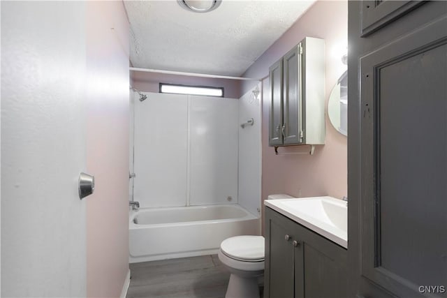 87 Kings Rd, Volney, NY 13069 - bathroom with a textured ceiling, toilet, vanity, wood finished floors, and bathing tub / shower combination