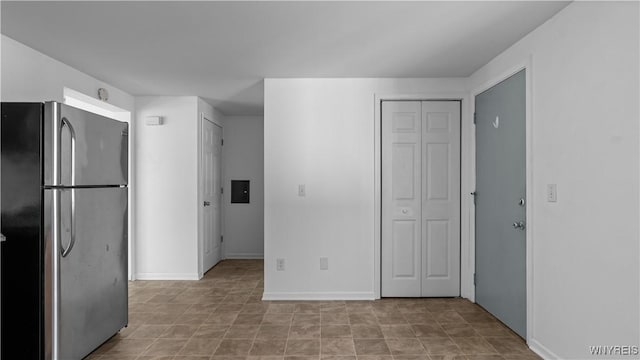 kitchen featuring freestanding refrigerator and baseboards