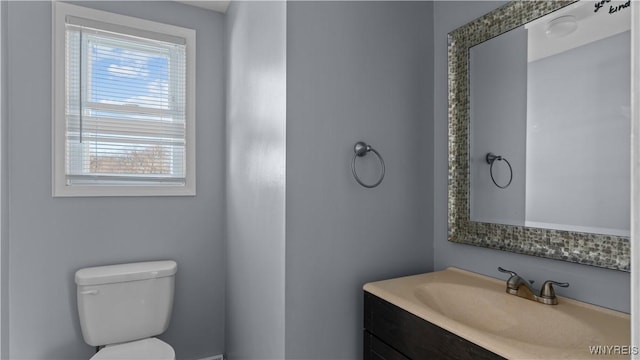 half bath featuring toilet and vanity