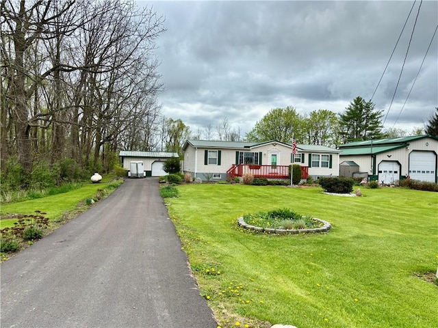 397 Jerrysmith Rd, Lansing, NY 14850 - view of front of property with a deck, an outdoor structure, a garage, and a front yard