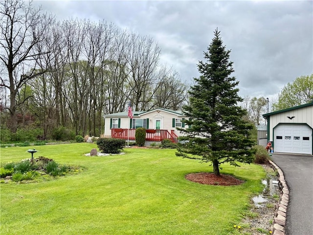 397 Jerrysmith Rd, Lansing, NY 14850 - manufactured / mobile home featuring aphalt driveway, a wooden deck, a front lawn, and board and batten siding