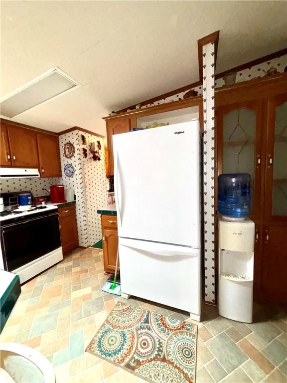 397 Jerrysmith Rd, Lansing, NY 14850 - kitchen featuring brown cabinetry, exhaust hood, and white appliances