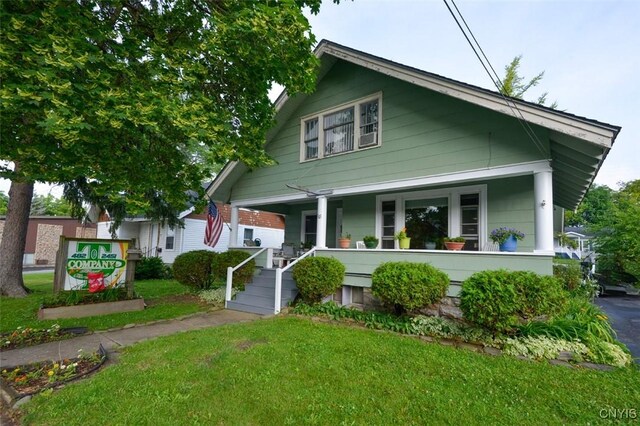 18 Crossmon St, Alexandria, NY 13607 - bungalow-style house featuring a porch and a front yard