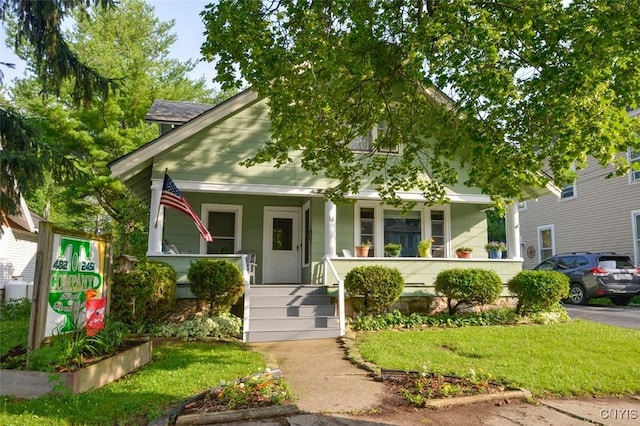 18 Crossmon St, Alexandria, NY 13607 - bungalow-style house featuring a front yard and covered porch