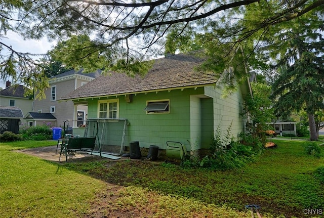 18 Crossmon St, Alexandria, NY 13607 - back of house featuring a lawn, a patio area, and a shingled roof