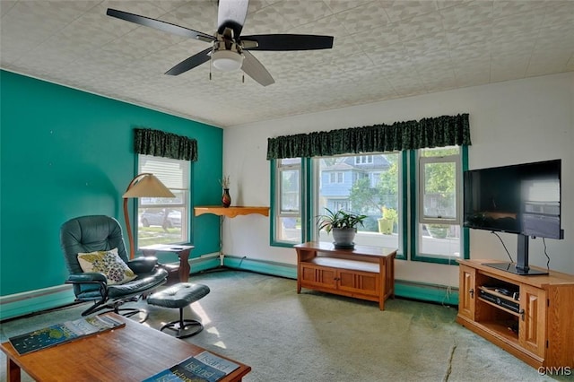 18 Crossmon St, Alexandria, NY 13607 - living area featuring carpet, baseboards, a ceiling fan, and a baseboard heating unit