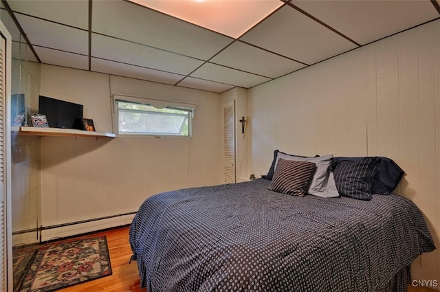 18 Crossmon St, Alexandria, NY 13607 - bedroom with a drop ceiling, a baseboard radiator, and wood finished floors