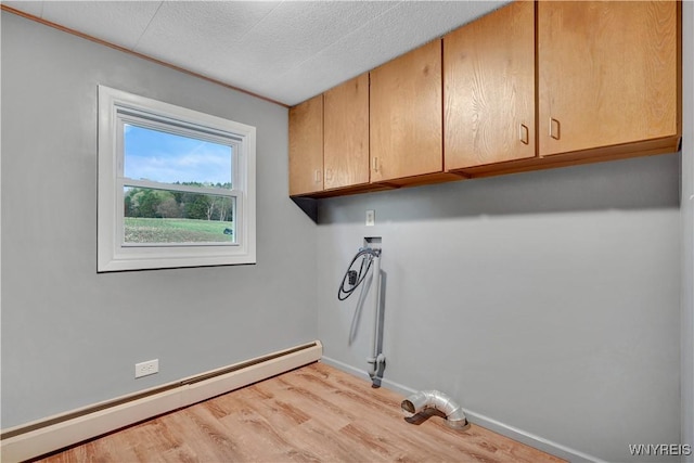 9862 Rte 219, Ashford, NY 14171 - laundry room with light wood finished floors, cabinet space, hookup for a washing machine, baseboards, and a baseboard heating unit