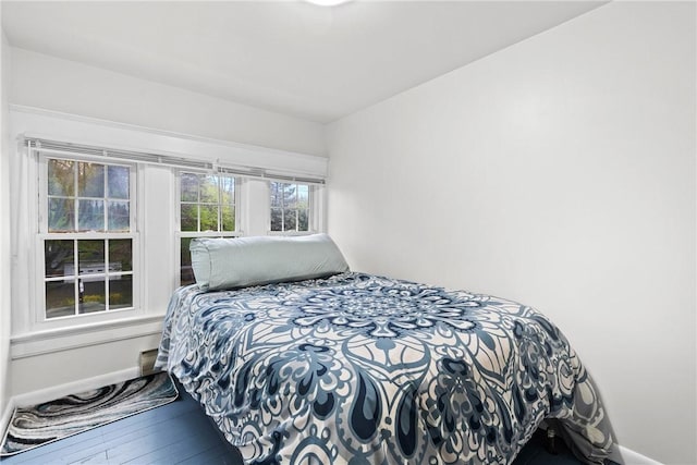 bedroom with baseboards and hardwood / wood-style floors