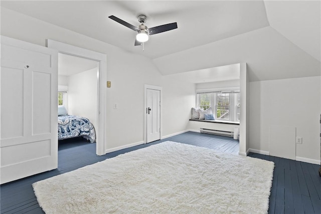 interior space with a ceiling fan, baseboards, dark wood-style flooring, vaulted ceiling, and a baseboard radiator