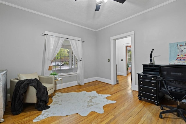 home office featuring ceiling fan, hardwood / wood-style flooring, crown molding, and baseboards