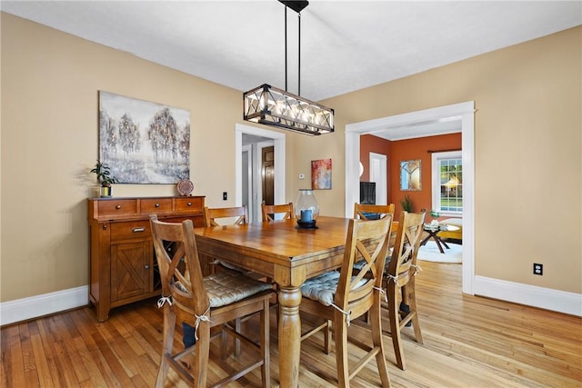 dining room featuring light wood-style floors and baseboards