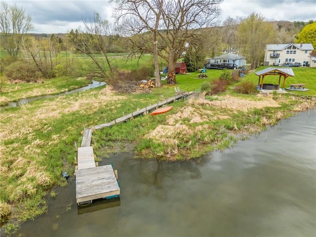 view of dock with a gazebo and a water view