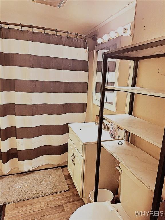 49 Grove St, Warsaw, NY 14569 - full bathroom with toilet, curtained shower, and wood finished floors