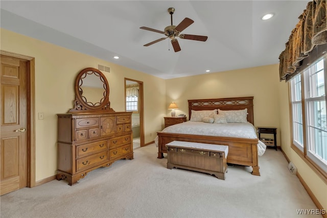 bedroom with light colored carpet, visible vents, baseboards, and recessed lighting