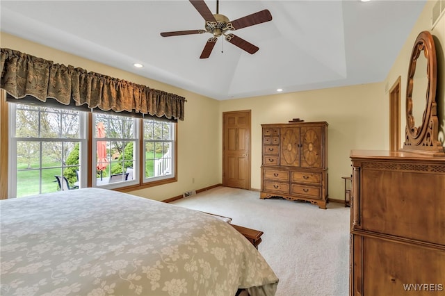 bedroom featuring baseboards, multiple windows, and light colored carpet