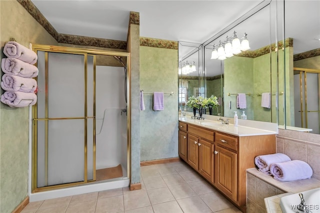 bathroom with vanity, tile patterned flooring, and a shower stall