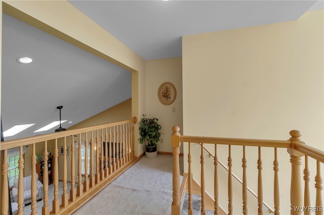 hall with carpet, an upstairs landing, baseboards, and recessed lighting
