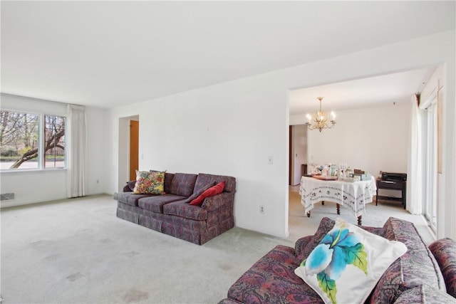 living room with a notable chandelier, visible vents, and carpet