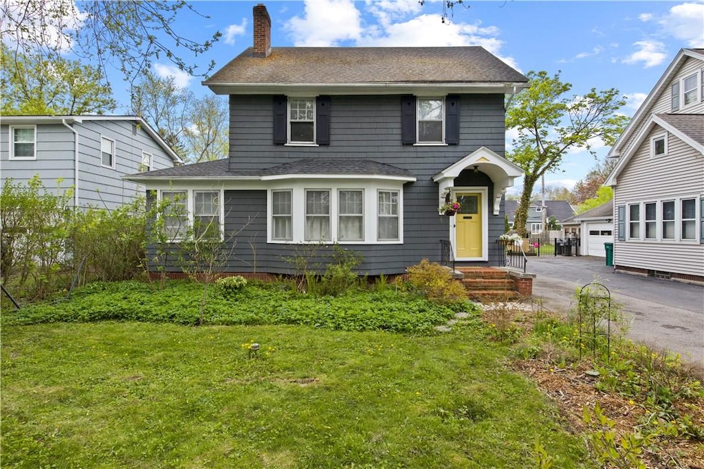 247 Fair Oaks Ave, Brighton, NY 14618 - traditional-style home featuring a shingled roof, a garage, a chimney, and a front lawn