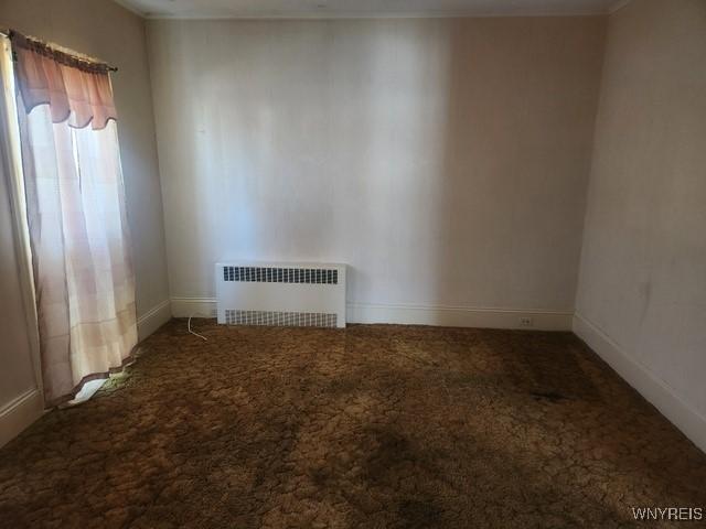 106 Saxton St, Lockport City, NY 14094 - empty room featuring baseboards, radiator, and carpet floors