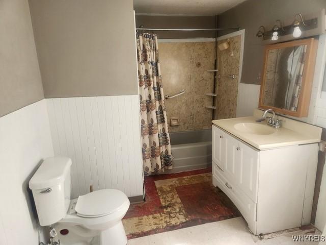 106 Saxton St, Lockport City, NY 14094 - bathroom featuring toilet, wood walls, vanity, shower / tub combo with curtain, and wainscoting