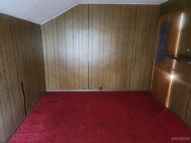 106 Saxton St, Lockport City, NY 14094 - spare room featuring carpet and wood walls