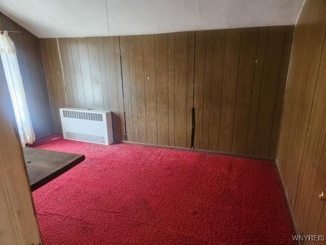 106 Saxton St, Lockport City, NY 14094 - carpeted empty room featuring wooden walls and radiator