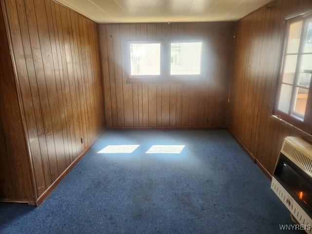 106 Saxton St, Lockport City, NY 14094 - empty room featuring carpet, a wealth of natural light, and wood walls