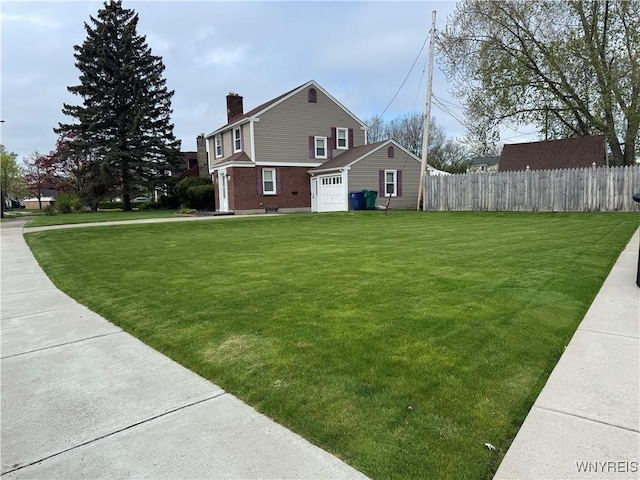797 Van Rensselaer Ave, Niagara Falls, NY 14305 - view of side of home featuring a chimney, a yard, brick siding, fence, and a garage