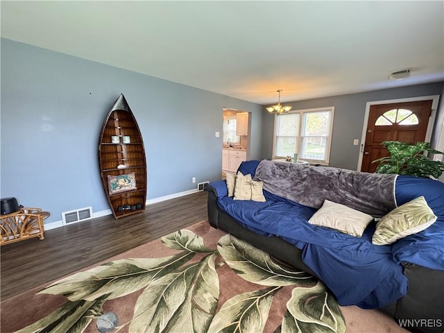 797 Van Rensselaer Ave, Niagara Falls, NY 14305 - living room featuring an inviting chandelier, visible vents, wood finished floors, and baseboards