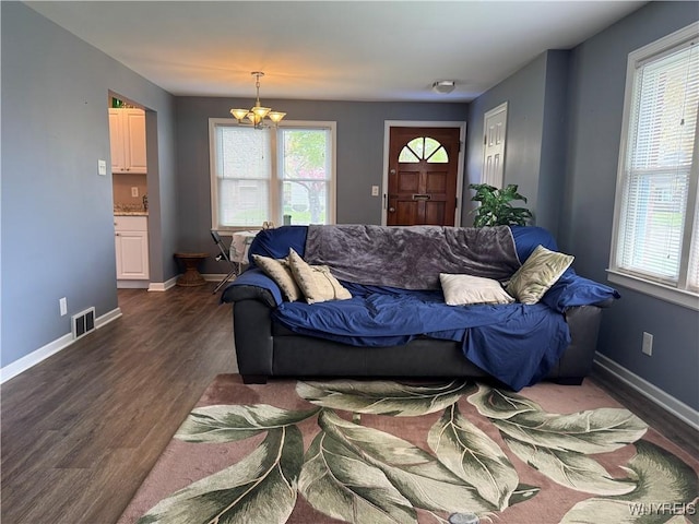 797 Van Rensselaer Ave, Niagara Falls, NY 14305 - living room with a wealth of natural light, an inviting chandelier, visible vents, and dark wood-style floors